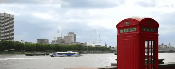 Telephone box in London with London Eye in background