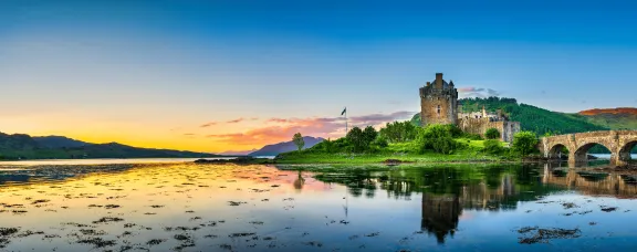 Scottish castle surrounded by loch