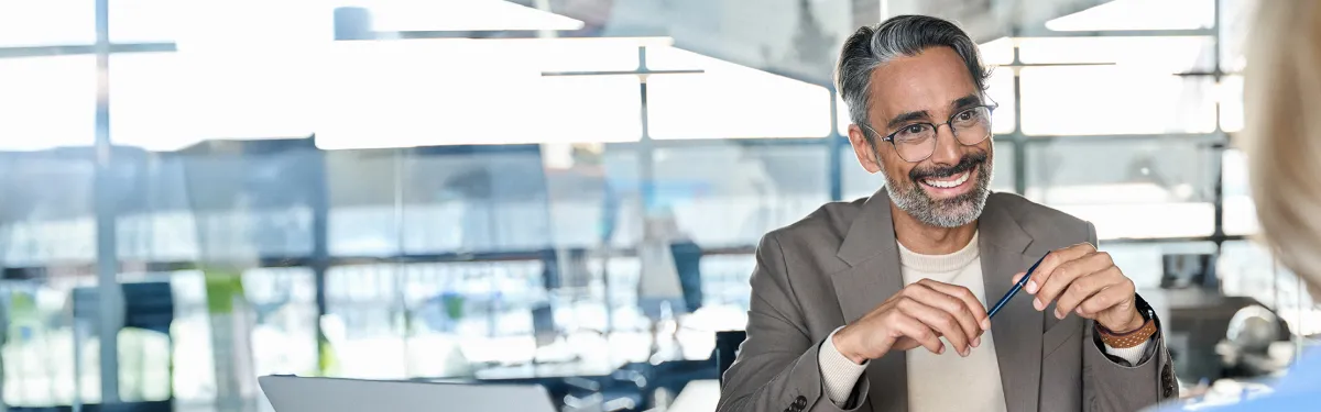 Male with glasses talking and smiling to client