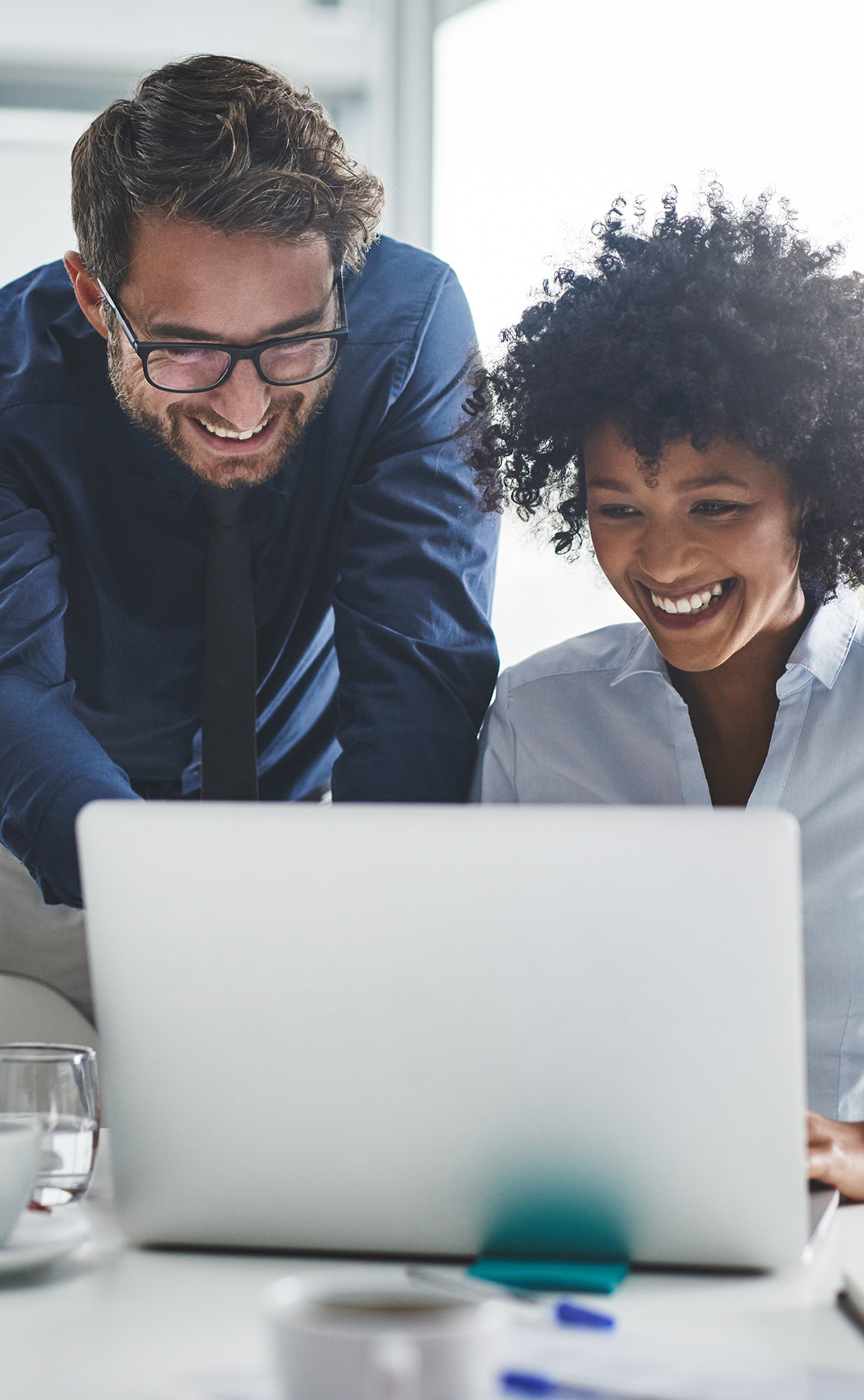 Two colleagues looking at a laptop