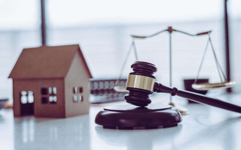 small wooden house, scales, gavel 