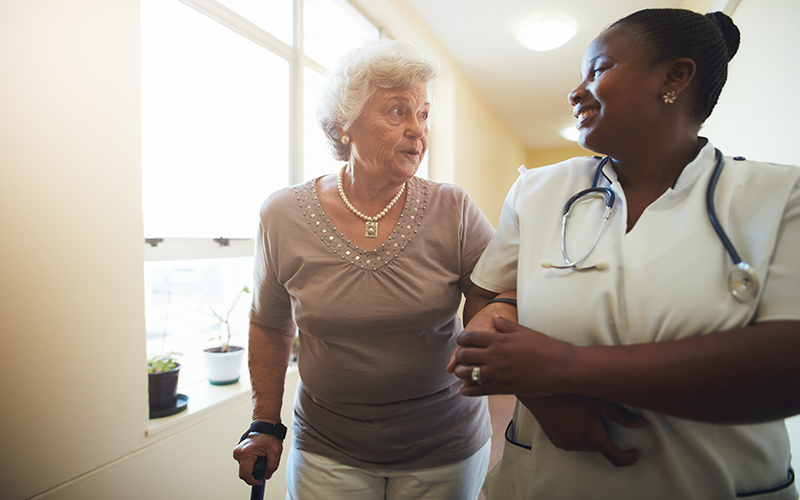 Care worker supporting an elderly lady