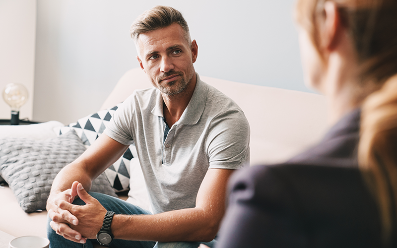 Man in deep thought, discussing with professional